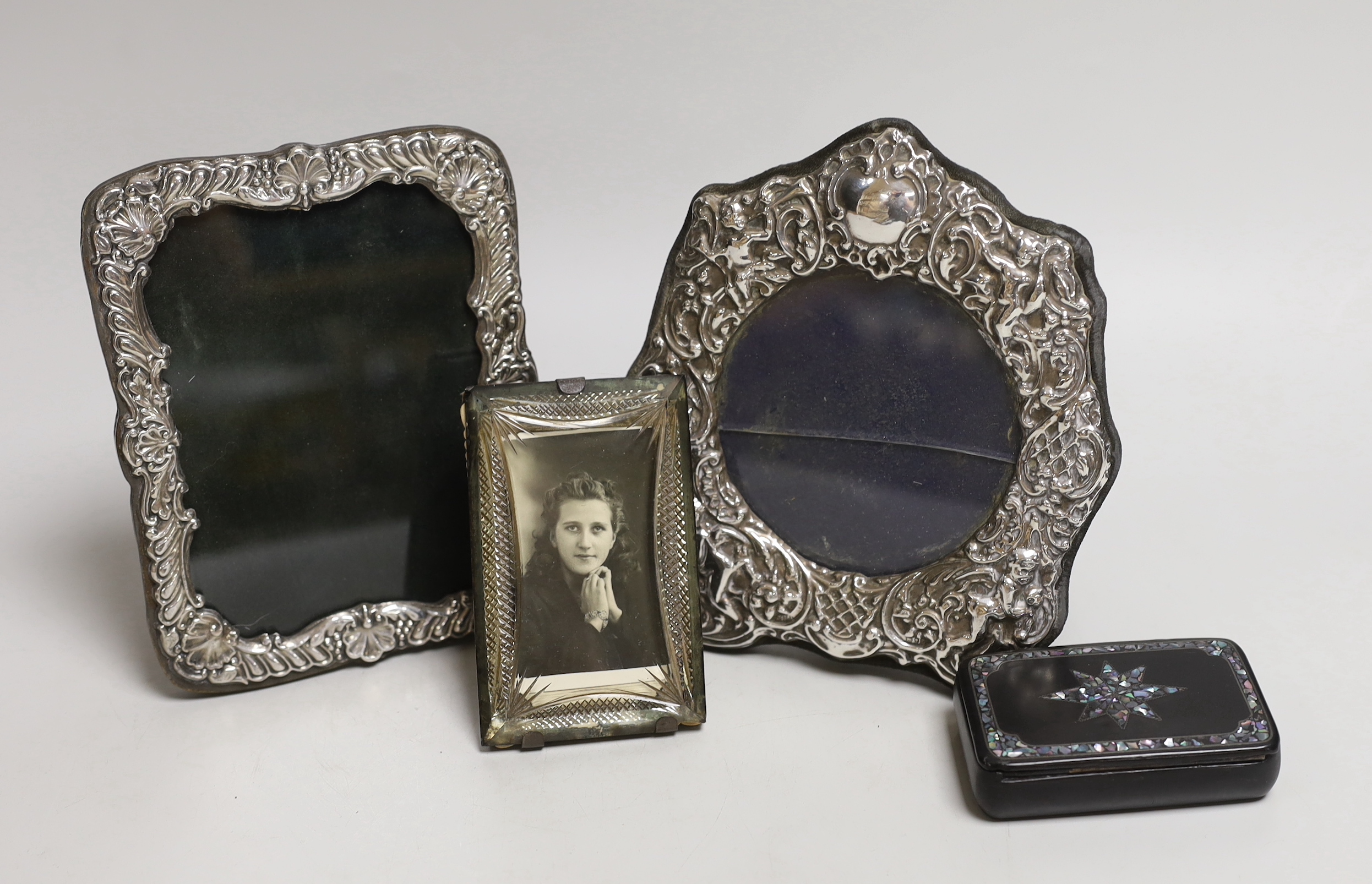 Two silver frames, a glass frame and a papier mache and mother of pearl snuff box